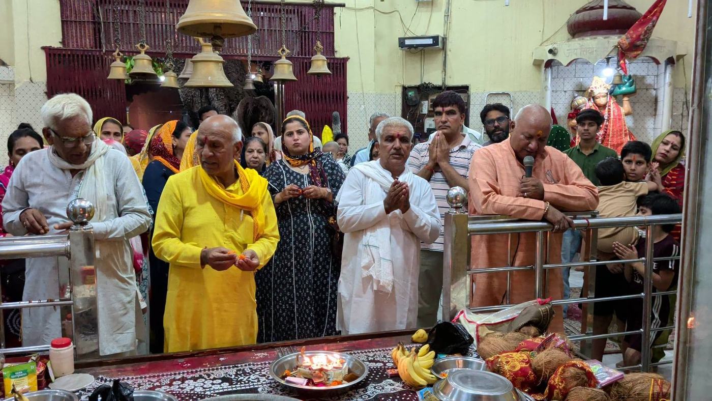 Devotees offering aarti at the sanctum doors