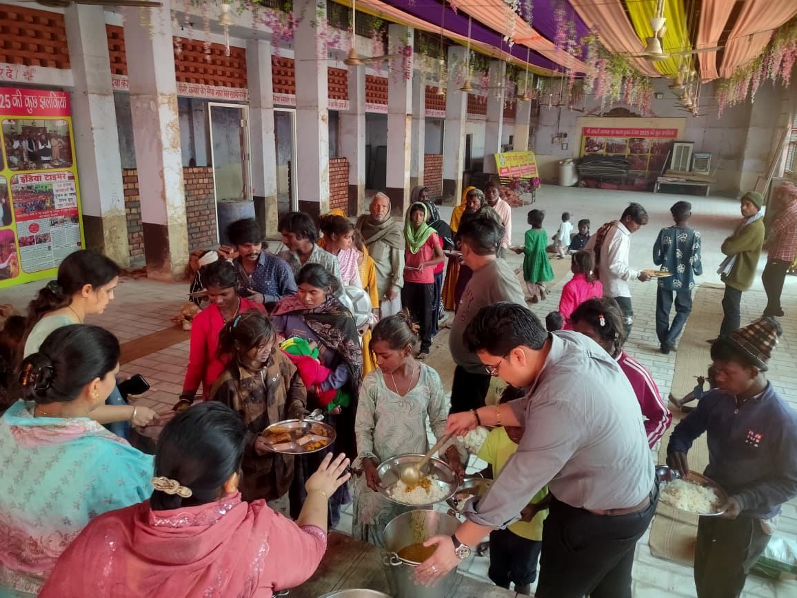 Volunteers serving a meal to devotees