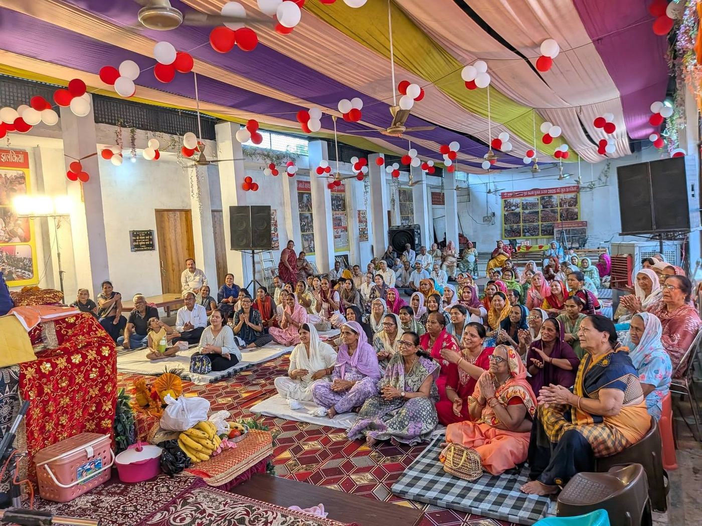 Women devotees gathered in the decorated hall