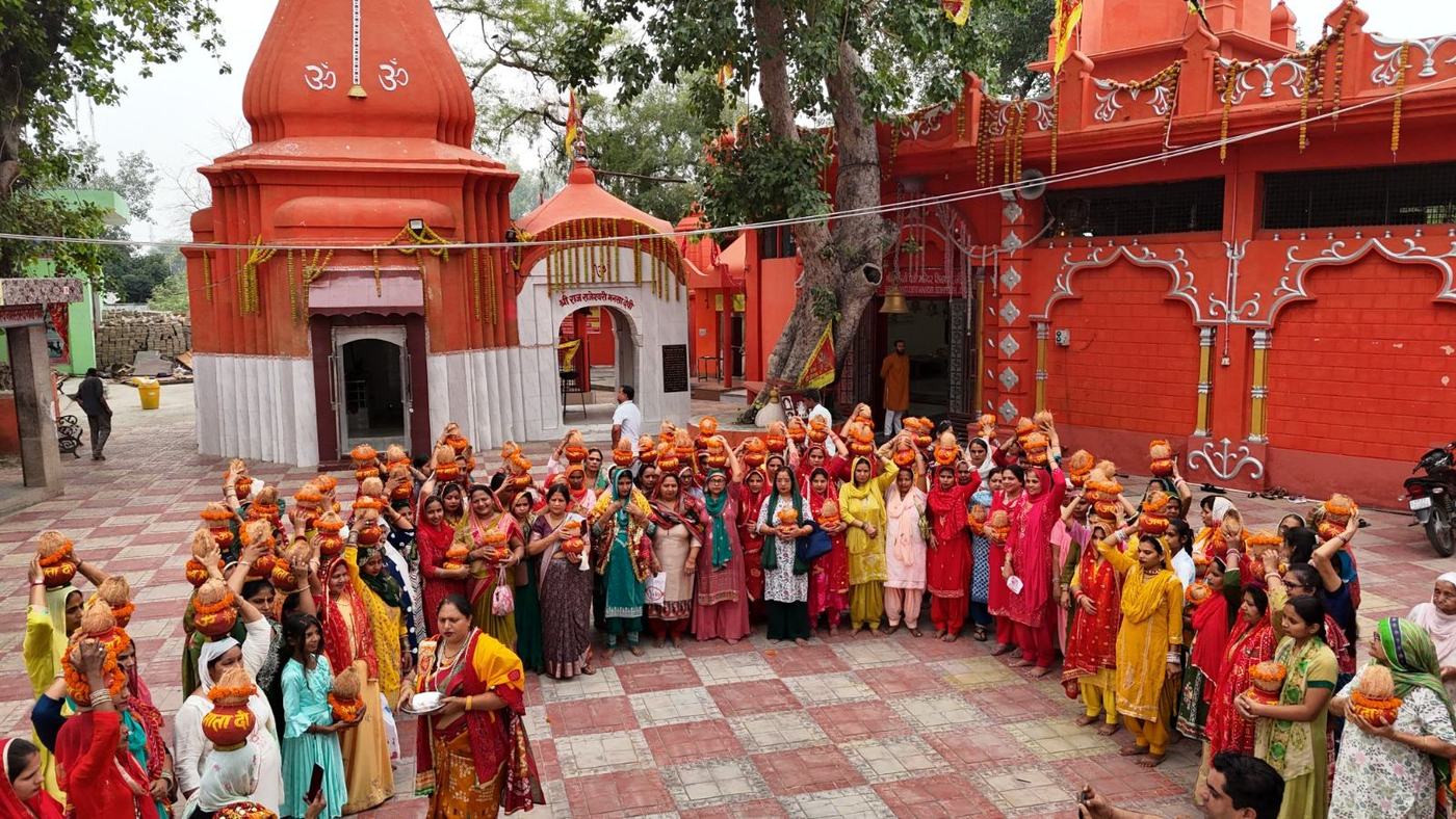 The temple shikhara with devotees carrying kalash
