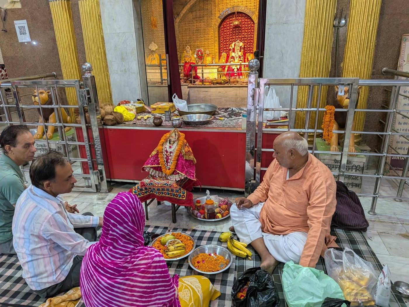 A priest guiding devotees through puja