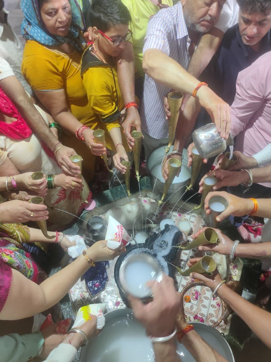 Devotees pouring milk in abhishek