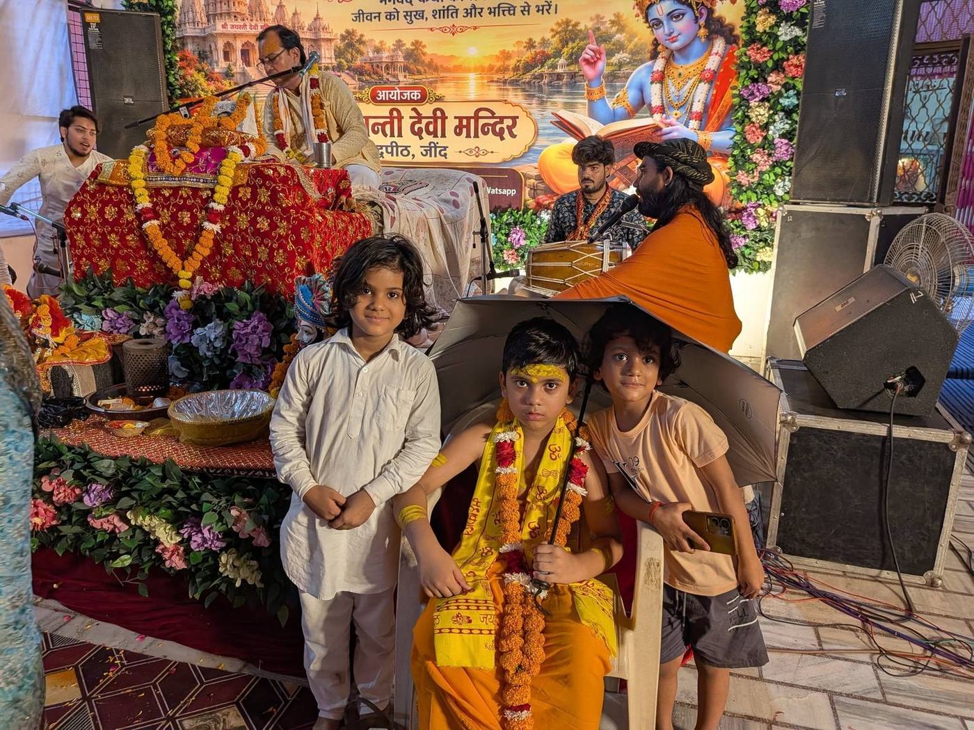 Children dressed for a devotional programme with the priest